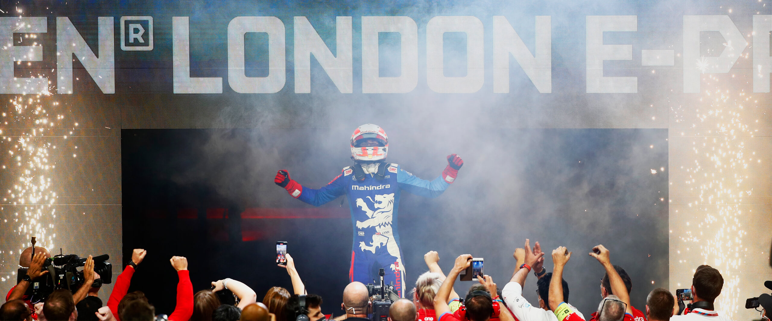 Champion of the London E-Prix celebrating with team mates on the podium