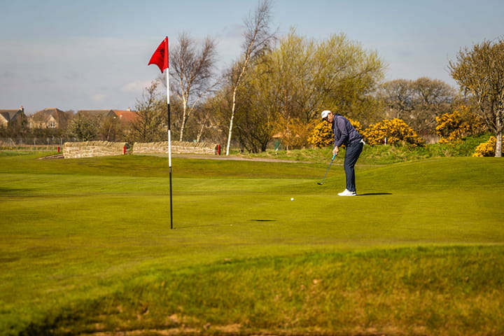 Putting on the signature hole at Carnoustie Golf Links, hole 16