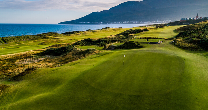 Royal County Down Golf Course green along with a view of the coastline