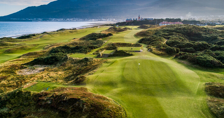 Royal County Down Golf Course green and fairway along with a view of the coastline