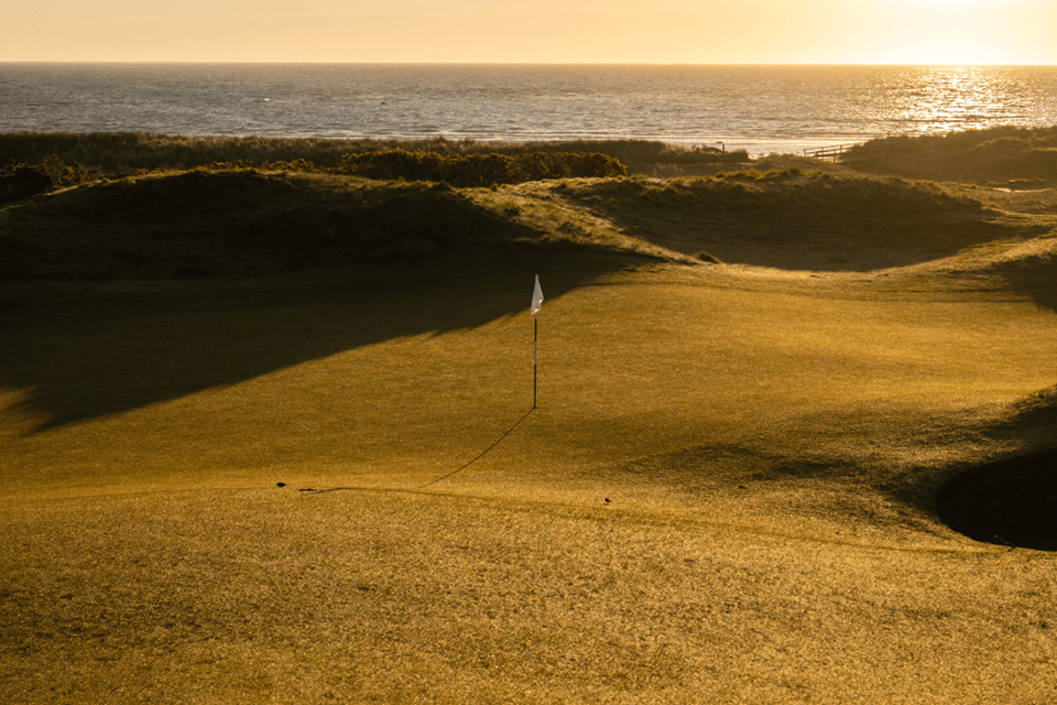Flag on the green at a coastal links golf course