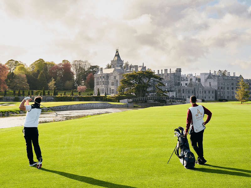 Golfers playing the 18th green at Adare Manor in Ireland