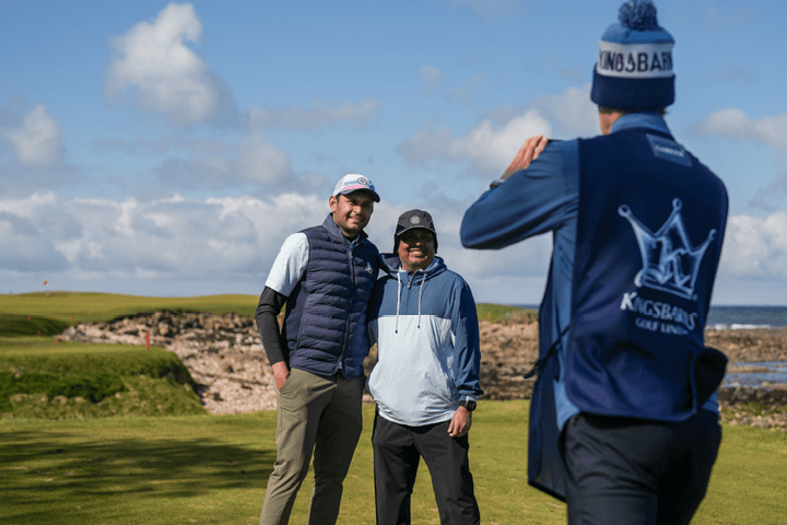 Guests taking a photo at Kingsbarns on the 15th Signature Hole