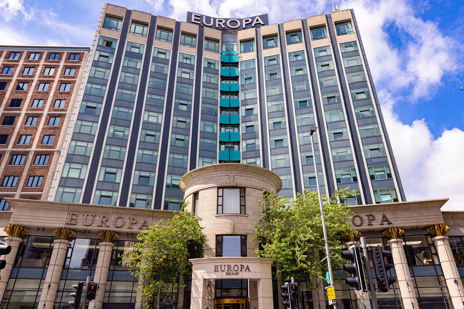 Exterior of Europa Hotel in Belfast, Northern Ireland on a sunny day.