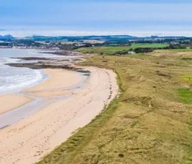 The beach and the golf course on the cliff at the Dumbarnie Links Golf Course in St Andrews in Scotland