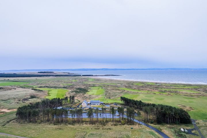View of the lake with trees surrounding the golf course on the Dumbarnie Links Course at St Andrews in Scotland