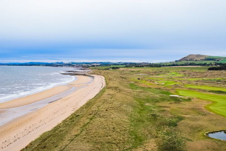 View of the beach and golf course on the cliff at the Dumbarnie Links Golf Course at St Andrews in Scotland