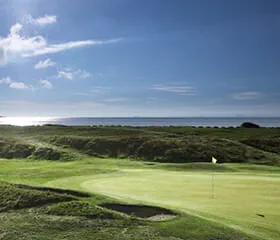 Views of the putting green and flagpole at the Leven Links Golf Course in St Andrews in Scotland