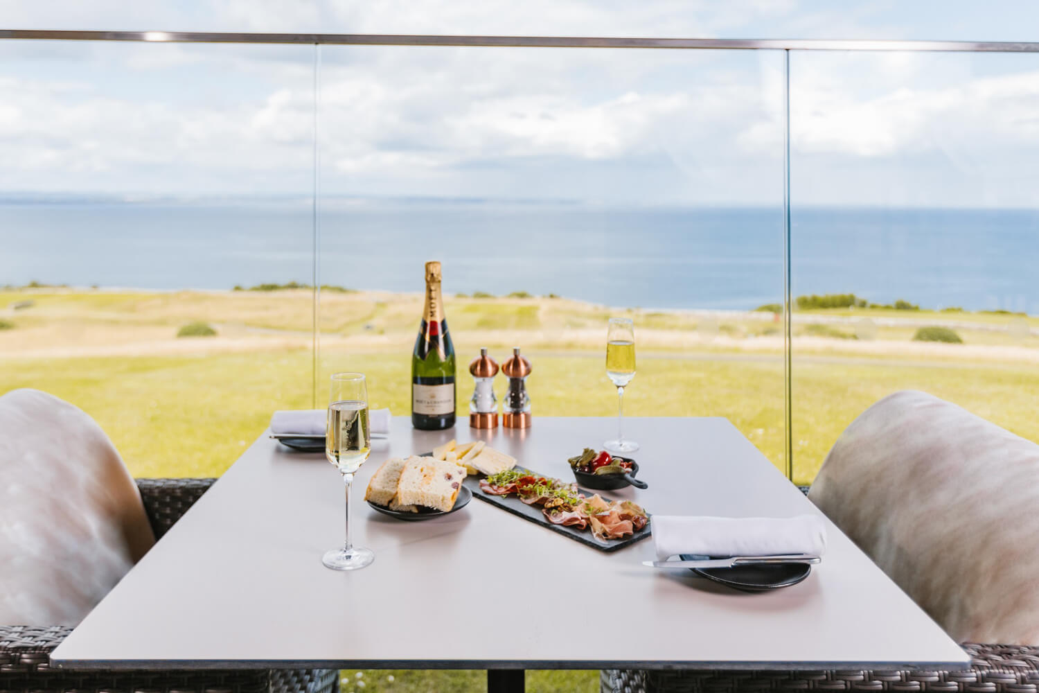 View of the course and sea from a table in the restaurant at the Fairmont Hotel in St Andrews Scotland 