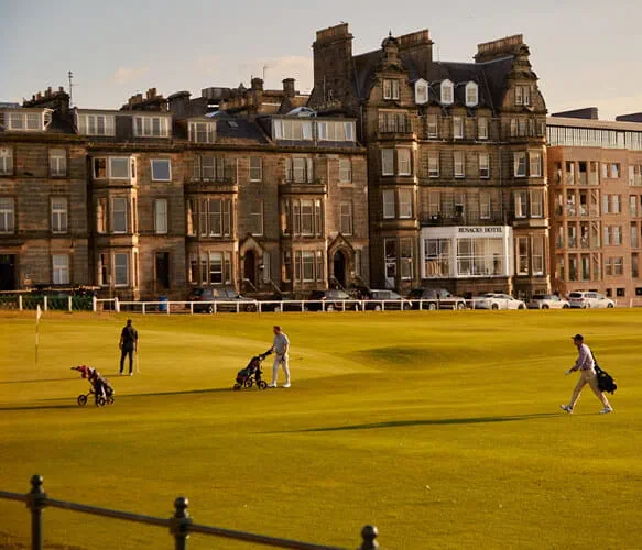View looking at the golf course and people playing gold at Rusacks Hotel in St Andrews in Scotland