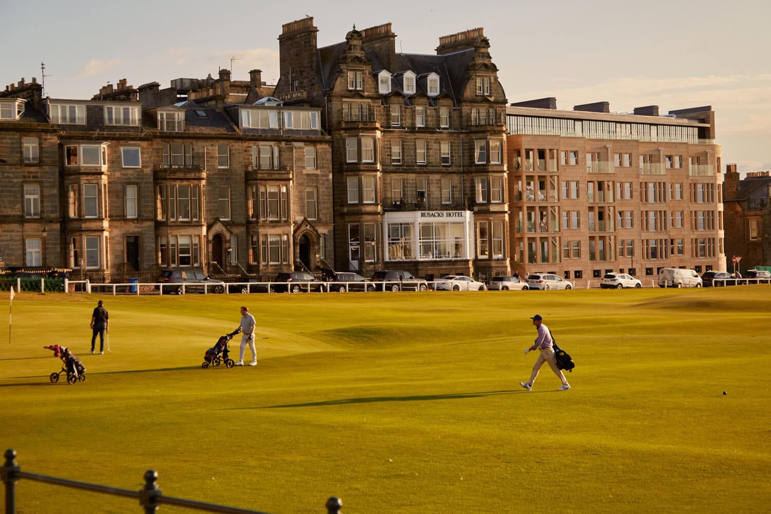 View looking at the golf course and people playing golf at Rusacks Hotel in St Andrews in Scotland