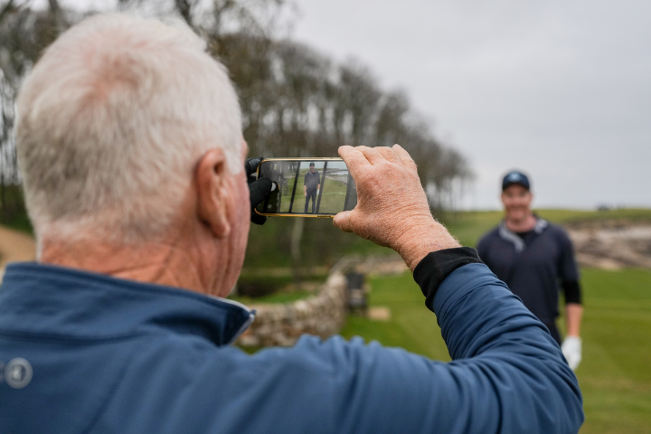 Guests of father and Son enjoying taking photos on Kingsbarns Links, Scotland.